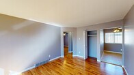 This single-floor, 3-bedroom, 1-bathroom home offers a practical and comfortable layout designed for efficient everyday living. Warm hardwood flooring runs throughout the main living areas and bedrooms, complemented by soft lavender-gray walls and clean white trim that create a calm, cohesive aesthetic.

The spacious primary bedroom is generously sized and includes a built-in closet with bi-fold doors, offering ample storage. The additional bedrooms feature hardwood or wood-look tile flooring, vertical blinds on the windows, and ceiling fans to enhance comfort and airflow. Each room receives solid natural light through multiple windows.

The kitchen stands out with white shaker-style cabinetry, granite-look countertops, a stainless steel sink, and a full suite of stainless steel appliances including a refrigerator, electric range, microwave, and double wall oven — a well-equipped space for home cooking.

The bathroom is clean and functional, featuring a full soaking tub with a shower, white tile surround, and a small window for ventilation.

A hallway connects the rooms efficiently, and the open living area benefits from a large picture window that invites natural light and outdoor views. Floor vents throughout indicate a central forced-air system, adding year-round climate control to this move-in-ready home.