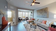 Located at 14037 Benvolio Cir in Orlando, Florida, this single-story residence offers a thoughtfully designed interior with contemporary finishes throughout. The open-concept living area is a standout feature, anchored by wood-look flooring, a ceiling fan, and a bright bay window nook that floods the space with natural light. This sun-drenched sitting area provides a comfortable retreat with outdoor views, flowing seamlessly into the main living space.

The kitchen is outfitted with dark wood cabinetry, granite countertops, a subway tile backsplash, and a full suite of stainless steel appliances, including a gas range, microwave, dishwasher, and refrigerator. Track lighting and a pendant fixture enhance both functionality and ambiance. A breakfast bar adds additional prep and dining space.

The bedrooms feature plush carpeting, ceiling fans, and windows that bring in natural light. The primary bedroom connects to a walk-in closet with wire shelving systems offering ample storage. The bathroom includes a granite-topped vanity with dark wood cabinetry, wood-look flooring, and a shower-tub combination. The overall design palette of neutral grays, warm wood tones, and modern fixtures creates a cohesive and inviting atmosphere throughout.