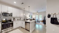 This well-designed single-floor residence offers a thoughtfully laid-out open-concept floor plan that seamlessly connects the kitchen, dining, and living areas. The kitchen is a standout feature, boasting crisp white cabinetry, granite countertops with a white and grey veining, a classic subway tile backsplash, and stainless steel appliances including a refrigerator with ice maker, microwave, and dishwasher. A central island with seating for multiple guests serves as both a functional workspace and a social hub, illuminated by modern globe pendant lights. Polished concrete floors run throughout the main living areas, lending an industrial yet refined aesthetic. The open living room is anchored by a ceiling fan and French doors that invite natural light and provide access to an outdoor space with views of surrounding greenery. The bedroom is bright and serene, featuring large windows with blinds, a ceiling fan, and neutral walls that create a calm and restful atmosphere. The bathroom maintains the home's contemporary palette with granite vanity countertops, white cabinetry, and a full tub and shower combination. Throughout the residence, a consistent use of neutral tones, modern fixtures, and clean lines creates a cohesive and inviting living environment.