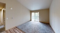 Located in Auburn, WA, this single-floor, 2-bedroom, 2-bathroom residence offers a practical and comfortable layout designed for everyday living. The combined dining room and kitchen serves as a central hub, featuring dark espresso cabinetry, stainless steel appliances including a refrigerator, range, and microwave, a peninsula with a single-basin sink, and light wood-style flooring that adds warmth to the space. Recessed lighting illuminates the kitchen and connecting hallway efficiently.

The living area transitions seamlessly from the kitchen, with a mix of hard flooring and carpet defining each zone. Both bedrooms are carpeted and generously sized, with the primary bedroom offering a notable footprint, a window with outdoor views, a baseboard heater, and direct access to a private en-suite bathroom. The bathrooms are finished with tile flooring, dark vanity cabinetry, wide mirrors, and one includes a full tub-shower combo with a grab bar.

Storage is a standout feature, with four closets throughout — including walk-in closets fitted with wire shelving systems. An in-unit laundry area and a private balcony add further convenience and functionality. The neutral color palette, clean lines, and thoughtful layout make this a well-organized and move-in ready residence.