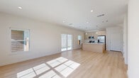 Located at 1525 FM 982 in Princeton, TX, this two-story home offers four bedrooms and three bathrooms across a well-designed layout. The main floor centers around a bright, open-concept kitchen and living area bathed in natural light from sliding glass doors that open to the outdoors. The kitchen is a standout feature, showcasing a large island with a quartz countertop and undermount sink, light wood cabinetry, a subway tile backsplash, stainless steel appliances, and elegant pendant lighting overhead. Light wood-style flooring flows throughout the main level, enhancing the clean, modern aesthetic. The upper floor houses the bedrooms, including a generously sized primary bedroom with a walk-in closet fitted with wire shelving. The primary bathroom features a glass-enclosed walk-in shower with floor-to-ceiling tile, a white quartz vanity, and gold-accented hardware. Secondary bedrooms are carpeted, bright, and well-proportioned, each with window blinds allowing natural light. A secondary full bathroom includes a tiled tub-shower combo with a curved rod and a clean white vanity. The home's neutral palette, recessed lighting, and thoughtful layout create a comfortable, move-in-ready living environment.