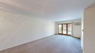 Located at 625 S Dilger Ave in Waukegan, IL, this 2-bedroom, 1-bathroom residence offers a well-organized single-floor layout designed for comfortable everyday living. The living room serves as the heart of the home, featuring plush carpeting, crisp white walls, and a set of wood-framed French doors that flood the space with natural light and provide views of the surrounding greenery. The kitchen is thoughtfully appointed with light flat-panel cabinetry, dark granite countertops, a stainless steel refrigerator, gas range, microwave, and dishwasher, all set atop sleek dark tile flooring. The primary bedroom is a comfortable retreat, carpeted and bright, with a wall-mounted air conditioning unit, a baseboard heating system, and a large window framing outdoor tree views. It also benefits from two closets, offering generous storage. The second bedroom mirrors the same calm aesthetic, with carpeting, natural light, and direct access to the outdoors via a sliding door. The bathroom features a dark granite vanity countertop, warm wood cabinetry, a mirrored medicine cabinet, and brushed nickel fixtures. A dedicated utility closet with an electrical panel completes the practical layout of this well-maintained residence.