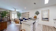 Located at 8240 Windsor Hill Blvd in North Charleston, SC, this single-floor, 2-bedroom, 2-bathroom home offers a thoughtfully designed open-concept layout with modern finishes and a warm coastal aesthetic. Light wood-tone flooring flows throughout, complementing the bright white walls and natural textures found in every room.

The kitchen is a standout feature, showcasing white shaker cabinetry, granite countertops, subway tile backsplash, stainless steel appliances, and a central island with seating — all opening directly to the living area. The living room is bright and inviting, with large windows allowing natural light to pour in, a ceiling fan overhead, and a striking textured accent wall that adds character and depth.

The spacious primary bedroom features an eye-catching botanical-print accent wall, wood-beam detailing, and direct access to an en suite bathroom. The second bedroom offers a cozy, refined feel with a textured neutral accent wall and closet access. Both bathrooms are finished with granite-topped white vanities and wood-look flooring, with one featuring a full soaking tub and shower combo.

The home also includes a dedicated closet for additional storage. The overall ambiance is cohesive and serene, blending modern convenience with relaxed, nature-inspired design elements.