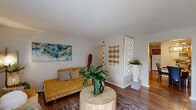 Located at 1500 Lorene Dr in Harvey, Louisiana, this single-floor, 3-bedroom, 2-bathroom home offers a well-organized layout across a comfortable footprint. The living room is a welcoming, open space featuring wood-look flooring and a sliding glass door that floods the area with natural light while providing access to an outdoor patio. The adjoining dining area and kitchen share a connected space, with the dining room highlighted by a modern geometric chandelier and a granite-topped breakfast bar pass-through. The kitchen is equipped with wood cabinetry, a full appliance suite including an electric range, over-the-range microwave, and refrigerator, all set on durable wood-look flooring. The primary bedroom offers a comfortable, carpeted retreat, while additional bedrooms also feature carpet flooring, ample closet storage, and natural light through windowed walls. Both bathrooms are efficiently designed, each featuring a vanity with wood cabinetry and white countertops; one includes a tub-shower combination. A connecting hallway ties the bedrooms and bathrooms together seamlessly. Throughout the home, neutral wall tones provide a versatile backdrop, and the overall layout makes efficient use of every room.