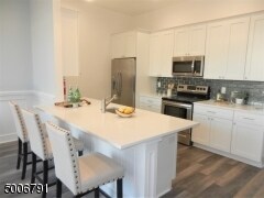 The Tasteful Galley Kitchen Is Equipped w/Quartz Counters, SS Appliances & Wood Cabinets - 346-3 Millburn Ave
