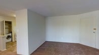 This single-floor space presents a straightforward and functional layout with a clean, move-in-ready aesthetic. The interior is characterized by smooth, neutral-toned walls painted in a soft, muted hue that lends a calm and understated atmosphere throughout. The flooring features wall-to-wall carpeting in a warm, earthy tone, providing comfort underfoot and a sense of coziness to the living areas. The ceiling is flat and white, complementing the light color palette and contributing to a bright, open feel. Standard electrical outlets are conveniently positioned along the walls, reflecting a practical and accessible design. The overall layout is open and unobstructed, offering flexibility for a variety of furniture arrangements and uses. The simplicity of the space makes it highly adaptable, whether configured as a living area, sleeping space, or multipurpose room. With its clean lines, neutral finishes, and carpeted floors, this single-story space provides a solid, versatile foundation well-suited for comfortable everyday living.