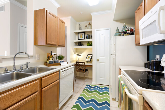 Kitchen with light brown cabinets and white appliances - Indigo Pointe