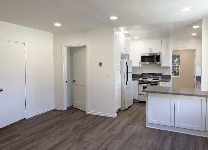 kitchen with counter seating and living room - 12230 W Magnolia Blvd