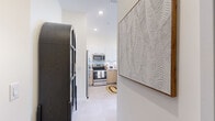 Located on the 9th floor at 16395 Biscayne Blvd in North Miami Beach, this well-appointed three-bedroom, one-bathroom residence offers a thoughtfully designed layout across a single floor. The contemporary kitchen serves as a central hub, featuring stainless steel appliances, warm wood cabinetry, crisp white upper cabinets, and a peninsula island with a built-in sink — ideal for both cooking and casual dining. Light-toned tile flooring runs throughout, enhancing the bright, airy atmosphere.

The primary bedroom is a comfortable retreat, complete with a dedicated walk-in closet and windows that frame elevated views of the surrounding cityscape. The two additional bedrooms are well-proportioned, each filled with natural light through large windows, offering flexibility for guests or a home office. A stylishly appointed bathroom showcases floor-to-ceiling marble-style tile in the walk-in shower, a frameless glass enclosure, and clean modern finishes.

A hallway connects the living spaces efficiently, while three closets provide ample storage throughout. The overall aesthetic is clean and modern, with warm neutral tones, recessed lighting, and an open feel that makes the most of the available space — a polished residence in the heart of North Miami Beach.