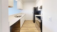 Located in Sandy, Utah, this single-story, one-bedroom, one-bathroom unit offers a clean and functional layout designed to maximize every square foot. Light wood-style flooring runs consistently throughout the space, creating a cohesive and bright aesthetic.

The open-concept living area connects seamlessly to the kitchen via a pass-through counter, allowing natural light from a large front-facing window to reach both spaces. The living room also features a wall-mounted air conditioning unit for year-round comfort.

The galley-style kitchen is well-appointed with white shaker cabinetry extending to the ceiling, white countertops, a stainless steel sink, and black appliances including a dishwasher, electric range, and refrigerator. Flush-mount ceiling lighting keeps the kitchen bright and practical.

The bedroom is a comfortable, well-proportioned room with a large window that invites natural light and offers exterior views. Two closets provide ample storage throughout the unit.

The bathroom features a full tub-shower combo with a white surround, a vanity with white cabinetry, brushed nickel fixtures, and matching wood-style flooring. The all-white palette throughout the unit creates a fresh, clean ambiance that is both modern and easy to personalize.