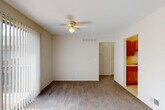 Located at 20205 Telegraph Road in Brownstown, MI, this 1-bedroom, 3-bathroom unit offers a well-organized single-floor layout designed for comfortable everyday living. The carpeted living room is a standout space, featuring a ceiling fan with light fixture and a full-width sliding glass door fitted with vertical blinds that fill the room with natural light and provide direct access to a private balcony with outdoor views. The layout flows seamlessly into a dedicated dining area and a galley-style kitchen outfitted with warm oak cabinetry, ample upper and lower storage, a double-basin stainless steel sink, and white appliances including a gas range and refrigerator. Light tile flooring runs throughout the kitchen. A carpeted hallway with built-in shelving connects the main living areas to the bedroom wing. The primary bedroom is a comfortable, well-proportioned space with plush carpet, neutral wall tones, and a bright window. Two closets provide generous storage. The bathrooms feature tile flooring, oak vanity cabinetry, wide countertops, and large mirrors. The unit's neutral color palette and consistent design elements create a clean, cohesive ambiance throughout.