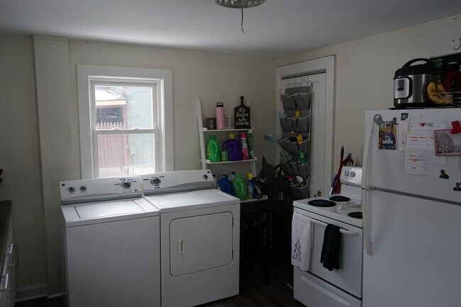 Kitchen with washer, dryer, stove, refrigerator - 619 S Water St