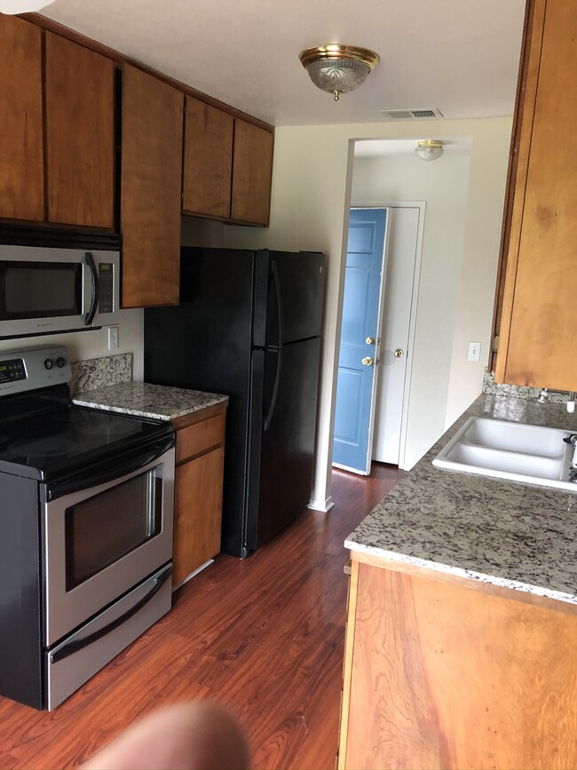 Kitchen with microwave, dishwasher, garbage disposal, and fridge - 445 Almond Dr. #29