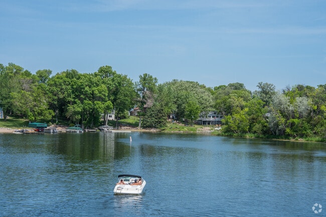 A boat leaving the bay towards lower Prior Lake.
