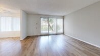 Located on Ocean Ave in Torrance, CA, this single-floor, 2-bedroom, 1-bathroom unit offers a practical and well-appointed layout. The living room features warm wood-look flooring, a ceiling fan, and large sliding glass doors framed by vertical blinds that fill the space with natural light and provide views of outdoor greenery. The open flow connects seamlessly to the kitchen, which stands out with white cabinetry, granite-style countertops, a mosaic tile backsplash, stainless steel appliances including a refrigerator, and track lighting — a functional and stylish centerpiece of the home. Both bedrooms are carpeted and feature textured ceilings, bright windows with vertical blinds, and sliding closet doors for ample storage. The primary bedroom is comfortably sized, offering a quiet retreat. The bathroom is equipped with a tub-shower combination featuring frosted sliding glass doors. Throughout the unit, clean white walls, consistent finishes, and a neutral palette create a cohesive and move-in ready atmosphere. The layout is efficient, with easy connectivity between living, kitchen, and bedroom spaces, making this unit a comfortable and functional home in the South Bay area of Los Angeles County.