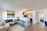 Located at 11500 Green Plaza Dr in Houston, TX, this single-floor, one-bedroom, one-bathroom residence offers a well-organized layout across a compact yet functional footprint. The open-concept living and dining area is bright and welcoming, featuring hardwood-style flooring, large windows, and sliding glass doors that flood the space with natural light while providing outdoor access. The living room offers ample room for comfortable seating arrangements, complemented by a textured ceiling and clean white walls.

The kitchen is efficiently designed with gray cabinetry, a subway tile backsplash, black appliances including a range and refrigerator, and a peninsula counter with bar seating — seamlessly connecting the kitchen to the dining area. An adjacent pantry provides useful additional storage.

The bedroom is a well-proportioned retreat, featuring a window with outdoor views, hardwood-style flooring, and two closets offering generous storage. The full bathroom is conveniently accessible directly from the bedroom.

A hallway connects the living areas to the private quarters, with built-in shelving adding practical storage. The entrance provides a welcoming transition into the home. Throughout the unit, the neutral color palette and consistent flooring create a cohesive, move-in-ready aesthetic.