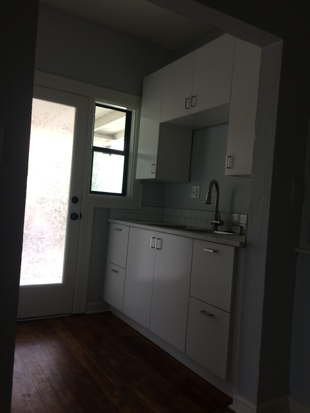 View of the East side of the kitchen. The glass door you see on the left leads to the carport. - 1819 North Laurel Avenue