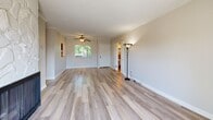 Located at 315 E Broadway in San Gabriel, CA, this well-appointed 3-bedroom, 2-bathroom single-story home offers a thoughtfully designed layout across a comfortable footprint. Light-toned wood flooring flows throughout, creating a cohesive and bright atmosphere in every room.

The open living area serves as the heart of the home, highlighted by a striking marble-surround fireplace with a sleek black firebox. A sliding glass door fills the space with natural light and opens to a private balcony, extending the living area outdoors. Crown molding and a textured ceiling add architectural character.

The galley-style kitchen features dark espresso cabinetry lining both walls, granite-look countertops, stainless steel appliances, and a window that brings in natural light — offering efficient functionality for everyday cooking.

The three bedrooms are well-sized, with the primary bedroom offering generous closet space fitted with mirrored sliding doors and a ceiling fan. Additional bedrooms are equally bright and comfortable, each with ceiling fans and ample storage.

Both bathrooms are cleanly finished with granite vanity countertops, framed mirrors, and glass-enclosed tub/shower combinations. Six closets provide abundant storage throughout the home, complemented by multiple hallways that create an intuitive flow between spaces.