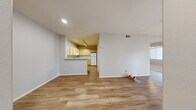 Located at 8400 S Maryland Pkwy in Las Vegas, NV, this single-floor, one-bedroom, one-bathroom unit offers a well-organized layout designed to maximize functionality. The open-concept living area features warm wood-look flooring throughout and neutral gray walls, creating a bright and welcoming atmosphere. Recessed lighting and a ceiling fan complement the natural light that filters in through vertical blinds.

The kitchen is positioned adjacent to the living area with a peninsula-style counter that opens to the main living space. It is outfitted with light wood cabinetry extending to the ceiling for ample storage, white appliances including a gas range, dishwasher, and over-the-range microwave, and clean white countertops.

The bedroom offers comfortable carpeted flooring, a ceiling fan, and access to a generously sized walk-in closet equipped with multiple shelving rods and built-in organizers. The full bathroom features a single-sink vanity with light wood cabinetry, a tiled tub-shower combo, and wood-look flooring.

A dedicated in-unit laundry room accommodates a full-size washer and dryer, adding everyday convenience. A hallway connects all rooms cohesively, completing this efficiently designed single-level home.
