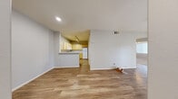 Located at 8400 S Maryland Pkwy in Las Vegas, NV, this single-floor, one-bedroom, one-bathroom unit offers a well-organized layout designed to maximize functionality. The open-concept living area features warm wood-look flooring throughout and neutral gray walls, creating a bright and welcoming atmosphere. Recessed lighting and a ceiling fan complement the natural light that filters in through vertical blinds.

The kitchen is positioned adjacent to the living area with a peninsula-style counter that opens to the main living space. It is outfitted with light wood cabinetry extending to the ceiling for ample storage, white appliances including a gas range, dishwasher, and over-the-range microwave, and clean white countertops.

The bedroom offers comfortable carpeted flooring, a ceiling fan, and access to a generously sized walk-in closet equipped with multiple shelving rods and built-in organizers. The full bathroom features a single-sink vanity with light wood cabinetry, a tiled tub-shower combo, and wood-look flooring.

A dedicated in-unit laundry room accommodates a full-size washer and dryer, adding everyday convenience. A hallway connects all rooms cohesively, completing this efficiently designed single-level home.
