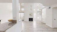 Located at 825 S Hobart Blvd in Los Angeles, this two-story, 2-bedroom, 2-bathroom home offers a clean, modern aesthetic defined by an all-white palette and light wood-style flooring throughout. The main floor is expansive, anchored by an open-concept living room featuring soaring ceilings, a classic fireplace with built-in wall niches, and abundant natural light streaming through vertical-slatted windows. A sculptural white spiral staircase serves as both a functional and architectural centerpiece, leading to the upper level. The well-appointed kitchen features crisp white shaker cabinetry with matte black hardware, granite countertops, stainless steel appliances, and recessed lighting, providing ample storage and prep space. Both bathrooms are finished with granite vanity tops, white cabinetry, and tub-shower combinations with glass sliding doors. The two bedrooms are bright and generously proportioned, with the primary bedroom offering comfortable square footage, recessed lighting, and easy access to additional closet space. Three closets throughout the home provide excellent storage. The upper floor offers a more intimate, private retreat. Clean lines, neutral tones, and thoughtful finishes give this home a move-in-ready appeal in the heart of Los Angeles.