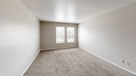 Located at 2141 Territory Ct in Saint Louis, MO, this 2-bedroom, 1-bathroom residence offers a practical and comfortable single-floor layout. The living room is a welcoming space featuring plush wall-to-wall carpeting, neutral beige walls, a textured ceiling, and a window that allows natural light to fill the room. A connecting hallway leads to the remaining areas of the home.

The primary bedroom is a generously sized retreat with dual windows that bring in natural light and offer outdoor views. It features soft carpeting, neutral-toned walls, and an expansive built-in closet. The second bedroom is equally well-appointed with its own window, carpeted floors, and a full-width closet, providing ample storage. Notably, this unit includes five closets throughout, offering exceptional storage capacity.

The kitchen is equipped with dark wood cabinetry, light speckled countertops, a stainless steel sink, and light flooring, providing a functional workspace. The bathroom features dark hardwood-style flooring, a tiled shower-tub combo, a vanity with cabinetry, and a toilet. Consistent textured ceilings and warm neutral walls carry throughout the home, creating a cohesive and understated aesthetic.