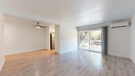 Located at 300 Rolling Oaks Dr in Thousand Oaks, CA, this 2-bedroom, 1-bathroom residence offers a well-designed single-floor layout with a clean, neutral aesthetic throughout. The open living room is bathed in natural light, courtesy of a large sliding glass door that leads to a private balcony overlooking mature eucalyptus and oak trees. Light wood-style flooring runs throughout the main living areas, complemented by crisp white walls and a ceiling fan that enhances comfort. A wall-mounted mini-split AC unit ensures year-round climate control.

The galley-style kitchen is efficiently laid out with white cabinetry, stone-look countertops, stainless steel appliances including a full-size refrigerator, and a window that brings in additional natural light. The bathroom features a full tub-shower combination with clean white finishes.

Both bedrooms are carpeted for warmth and comfort. The spacious primary bedroom includes a walk-in closet with built-in dual shelving systems, offering generous storage. The second bedroom also features a window with natural light. A dedicated closet rounds out the storage options within the unit. The lush, tree-lined balcony view adds a serene, nature-connected feel to this Thousand Oaks residence.