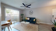 Located at 5615 N 7th St in Phoenix, AZ, this single-floor unit offers a well-designed layout that balances comfort and modern style throughout. The living area serves as the heart of the home, featuring wood-look flooring, a ceiling fan, and a large sliding glass door framed by vertical blinds that floods the space with natural light and provides direct access to an outdoor patio. The open feel of the living area also accommodates a dedicated workspace, making it functional for everyday living. The galley-style kitchen is a standout feature, showcasing bold navy subway tile backsplash, white cabinetry, dark countertops, and stainless steel appliances including a refrigerator, range, microwave, and dishwasher. The bedroom is a serene retreat finished with plush carpet, a ceiling fan, and a window that brings in natural light. A spacious walk-in closet with built-in shelving provides generous storage. The bathroom features a modern floating vanity with a vessel-style sink and wood-tone cabinetry, complemented by light wood flooring. The overall aesthetic throughout the unit is clean and contemporary, with neutral tones that create a cohesive and inviting atmosphere.