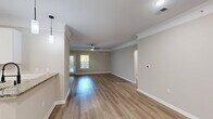This 2030 square foot residence in Raleigh, NC offers a harmonious blend of space and comfort. The two-story home boasts 3 bedrooms, including a generous 220 square foot primary suite, and 2 full bathrooms. The interior showcases a modern aesthetic with neutral tones and contemporary finishes throughout.

The main living areas feature durable, light-toned wood-look flooring, creating a warm and inviting atmosphere. Crown molding adds a touch of elegance to the rooms, which are illuminated by a combination of natural light from windows and modern ceiling fixtures, including stylish ceiling fans.

The kitchen is equipped with stainless steel appliances, granite countertops, and a mix of light and dark cabinetry, providing both style and functionality. Bathrooms are designed with clean lines, featuring white fixtures and ample vanity space.

Storage is plentiful with three closets, including a walk-in closet with wire shelving systems. The home's layout includes two hallways for easy navigation between rooms.

A standout feature is the balcony, offering views of the surrounding greenery and creating an ideal outdoor living space. The property is nestled among mature trees, providing a sense of privacy and connection to nature.

Located at 10022 Meadow Chase Drive, this home combines modern amenities with a serene setting, making it an attractive option for those seeking a contemporary living space in a tranquil Raleigh neighborhood.
