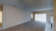 Located in Dallas, Texas, this single-story space offers a clean and functional layout designed for comfortable everyday living. The main living area is generously proportioned, featuring plush wall-to-wall carpeting that adds warmth underfoot. A textured ceiling with recessed lighting provides a neutral overhead finish, while HVAC vents are thoughtfully integrated throughout. Large sliding glass doors dressed with vertical blinds allow an abundance of natural light to flood the space and offer a direct view to the outdoors. The neutral, light-toned walls create a bright and versatile backdrop, making the space easy to furnish and personalize. A doorway visible from the main living area leads to an adjacent room, hinting at a connected and practical floor plan. The overall ambiance is open, airy, and move-in ready, with a straightforward design that prioritizes livability. The single-floor layout ensures easy accessibility and seamless flow throughout, making it a practical and welcoming environment in the heart of Dallas.