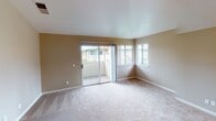 Located at 2355 Meadow Way in Santa Rosa, California, this single-floor apartment offers a well-designed layout with a variety of functional living spaces. The living area is generously sized, featuring plush carpeting, warm neutral-toned walls, and a sliding glass door that opens to a private balcony, allowing for an abundance of natural light and outdoor views of the surrounding community.

The kitchen is outfitted with crisp white cabinetry, light speckled countertops, and stainless steel appliances including a range and an over-the-range microwave, providing a clean and efficient workspace for cooking and entertaining.

The bedrooms are carpeted and feature ceiling fans with light fixtures, offering comfort and airflow throughout. One bedroom benefits from vaulted ceilings and includes a mirrored sliding-door closet, while windows invite in natural light. Additional rooms transition to warm hardwood flooring, lending a cohesive yet varied character to the unit.

The bathroom is neatly appointed with white cabinetry, a light stone-toned countertop, a single sink, and a well-lit vanity mirror with an overhead light bar, all set atop hardwood flooring. The overall aesthetic throughout the apartment is clean and neutral, creating a bright, move-in ready atmosphere suitable for comfortable everyday living.