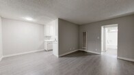 Located at 1628 W 218th St in the Torrance neighborhood of Los Angeles, this one-bedroom, one-bathroom unit offers a practical and well-organized single-floor layout. The living room serves as the main gathering area, featuring light gray laminate flooring, a textured ceiling, neutral gray walls, and a large window fitted with vertical blinds that invites natural light into the space. The open-concept design allows the living area to flow seamlessly toward the kitchen, which is separated by a partial wall. The kitchen is equipped with white cabinetry, speckled laminate countertops, and a sink, providing efficient functionality in a compact footprint. A wall-mounted heating unit is positioned in the main living area for year-round comfort. The bedroom is a well-proportioned private retreat, also finished with laminate flooring and a window with vertical blinds that brings in abundant natural light. The bathroom features a full-size soaking tub and shower combo with clean white finishes and a standard toilet. Throughout the unit, a consistent neutral color palette of whites and soft grays creates a clean, cohesive aesthetic. The streamlined design and efficient use of space make this unit a functional and comfortable home.