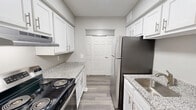 This 770 square foot apartment in Lakeside Landing offers a thoughtfully designed living space with 2 bedrooms and 3 bathrooms. The single-floor layout maximizes efficiency, with the primary bedroom measuring 140 square feet. The interior boasts a modern aesthetic with neutral gray walls and plush carpeting in the bedrooms and living areas, creating a cozy atmosphere.

The kitchen showcases contemporary white cabinetry, granite countertops, and stainless steel appliances. Wood-look flooring in the kitchen adds warmth and durability. Bathrooms feature clean lines with white fixtures and vanities, complemented by large mirrors and good lighting.

Large windows in the bedrooms and living room allow for ample natural light, while vertical blinds on sliding glass doors provide privacy and light control. The living room is spacious, offering flexibility for furniture arrangement. Built-in closets in the bedrooms provide storage solutions.

Throughout the apartment, recessed lighting and textured ceilings add to the modern feel. The neutral color palette and updated finishes create a blank canvas for personalization, making this compact yet well-appointed space ideal for comfortable, contemporary living.