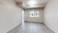Located at 772 Paisley Rd in Guelph, Ontario, this well-designed 2-bedroom, 2-bathroom unit offers a thoughtful layout across a single floor. The open-concept living, dining, and kitchen area forms the heart of the unit, finished with light grey wood-look flooring that runs throughout. The kitchen is a standout feature, equipped with stainless steel appliances including a refrigerator, stove, and built-in microwave, complemented by crisp white cabinetry, a grey quartz-style countertop, and a peninsula with an integrated sink — illuminated by stylish pendant lights overhead. The spacious living and dining area is bathed in natural light from large windows with outdoor views. The primary bedroom is a comfortable, well-sized room with its own window, while the second bedroom offers a clean, neutral space with natural light. The two bathrooms are finished in a consistent, modern style — one featuring a glass-enclosed stand-up shower with a sleek vanity, and the other a full soaker tub. A dedicated in-suite laundry room houses a full-sized Whirlpool washer and dryer with overhead shelving. The unit also includes a private balcony and a closet for additional storage.
