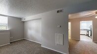 Located at 6729 Ramblewood Dr in Fort Wayne, Indiana, this single-floor home offers four bedrooms and one bathroom within a compact, efficiently arranged floor plan. The interior features a neutral color palette with gray-toned walls and textured ceilings throughout most of the living areas.

The kitchen is well-appointed with white cabinetry, dark countertops, and a full suite of black appliances including a gas range, dishwasher, and refrigerator. Light wood-look flooring and a window providing natural light give the kitchen a bright, functional character.

The bedrooms are carpeted and vary in size, with the primary bedroom offering generous proportions and two closet doors. Other bedrooms include a window for natural light, and one features a walk-in closet with built-in shelving. Ceiling fans are present in select rooms. The primary bedroom provides direct access to the laundry area, which houses a stacked washer and dryer unit.

The bathroom is finished with light wood-look flooring, a vanity with storage, and a shower/tub combination. A dedicated laundry space with a stacked washer and dryer adds everyday convenience. The home's straightforward layout, practical finishes, and included appliances make it a functional option in the Fort Wayne area.