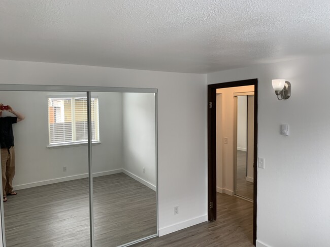 Bedroom #2 has ALL NEW LVP Floors, Blinds, Mirrored Closet Doors, Light Fixtures, and Fresh Paint. - 212 Spruce St E