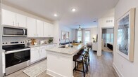 Located at 3730 Dupont Avenue in Jacksonville, FL, this well-appointed one-bedroom, one-bathroom residence offers a thoughtfully designed open-concept floor plan across a single level. The kitchen and living area flow seamlessly together, anchored by a striking granite-topped island with bar seating — ideal for casual dining or entertaining. The kitchen is equipped with stainless steel appliances, including a French door refrigerator, electric range, and microwave, complemented by crisp white cabinetry, a tile backsplash, and recessed lighting. Wood-look flooring runs throughout the main living areas, adding warmth and continuity to the space. The living room is bright and inviting, featuring a ceiling fan, multiple windows with natural light, and access to an outdoor area. The bedroom is a comfortable retreat with a ceiling fan, large windows with blinds and drape panels, and ample floor space. The bathroom echoes the home's modern aesthetic with granite countertops, white cabinetry, and wood-look flooring. Additional spaces include a utility room, closet, and a dedicated entrance. The overall ambiance is clean, contemporary, and move-in ready.