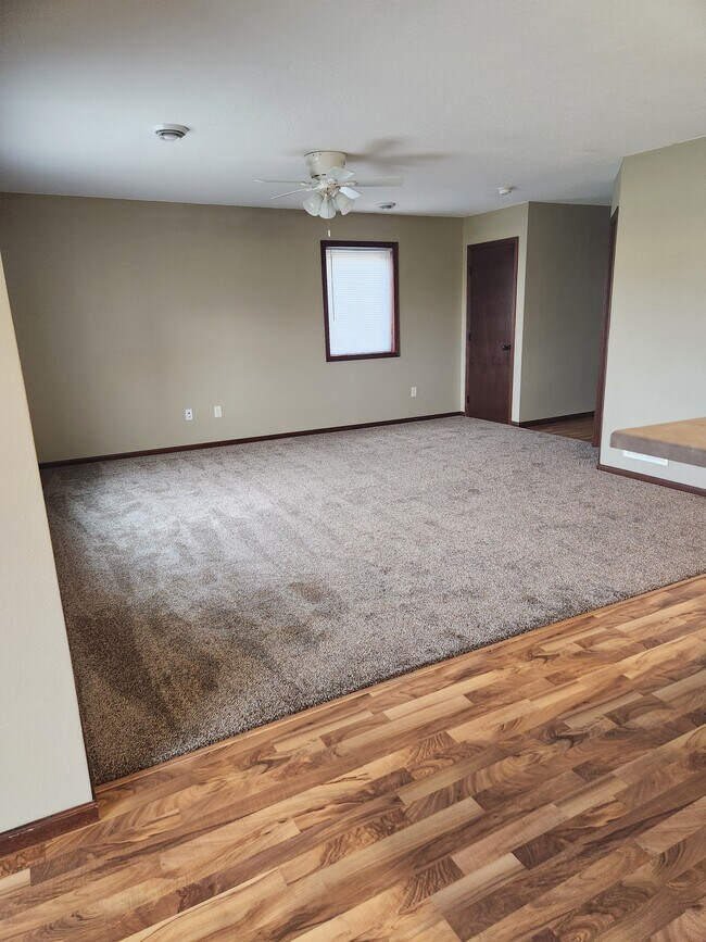 Open living room with brand new carpet - 124 Burg Ave