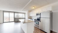 Located at 1350 15th St in Fort Lee, NJ, this well-appointed one-bedroom, one-bathroom residence offers a thoughtfully designed single-floor layout. The open-concept kitchen and living area serves as the heart of the home, featuring warm hardwood-style flooring that flows throughout. The kitchen is equipped with stainless steel appliances — including a refrigerator, electric range, and dishwasher — complemented by crisp white shaker cabinetry, granite countertops, and a central peninsula that provides additional workspace and a natural division between the kitchen and living area. The living room is bright and airy, benefiting from large sliding glass doors that open to a private balcony offering views of the surrounding Fort Lee skyline. The spacious primary bedroom features its own sliding window with outdoor views, a wall-mounted HVAC unit, and generous proportions. Two closets provide ample storage throughout the unit. The full bathroom is finished with light tile flooring and includes a grab bar for added accessibility. Clean white walls and consistent flooring choices throughout lend the space a cohesive, modern aesthetic. Two closets provide practical storage solutions to complete this efficient and comfortable residence.