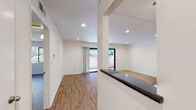 Located at 575 Hampshire Rd in the desirable community of Westlake Village, California, this single-story unit offers a clean, modern aesthetic throughout. Wood-look flooring flows seamlessly across every room, creating a cohesive and inviting atmosphere.

The open living area is bright and airy, illuminated by recessed lighting and a generous sliding glass door that leads to a private outdoor patio, allowing natural light to pour in and providing a seamless indoor-outdoor connection. A half-wall with a dark countertop divides the living space from the adjacent areas, adding a subtle architectural detail to the open layout.

The galley-style kitchen is well-appointed with crisp white shaker cabinetry, dark countertops, and a full suite of stainless steel appliances, including a refrigerator, electric range, and microwave. Recessed lighting keeps the kitchen bright and functional.

The bedrooms are generously sized and feature large windows that frame views of the surrounding greenery, filling each room with natural light. Both bathrooms maintain the same clean design language, outfitted with white vanity cabinetry, dark countertops, vessel sinks, and wood-framed mirrors. One bathroom includes a tub-shower combination, while the other features a stand-up glass-door shower. A ceiling fan in the dining area adds comfort to the space.