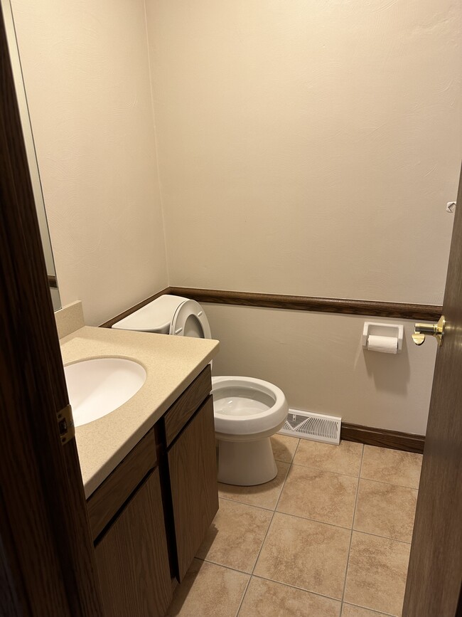 Half bath on first floor. New counter, sink and toilet. - 3852 Canterbury Dr