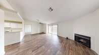 Located in Henderson, Nevada, this single-story, 2-bedroom, 2-bathroom home offers a well-organized layout with a comfortable and functional design throughout. The open living room is a standout feature, showcasing rich wood-style flooring, a textured ceiling, a ceiling fan, and a cozy fireplace. A sliding glass door floods the space with natural light and provides outdoor access, enhancing the airy ambiance of the main living area. The kitchen is efficiently designed with ample white raised-panel cabinetry, white appliances including a gas range and full-size refrigerator, and wood-style flooring that ties seamlessly into the rest of the home. Both bedrooms are carpeted for warmth and comfort, with the spacious primary bedroom featuring a dedicated walk-in closet. The second bedroom benefits from natural light through a window and convenient proximity to the living area. Each of the two bathrooms is clean and functional, equipped with a tub-shower combination, wood-style flooring, and bright white fixtures. Two closets throughout the home provide additional storage. The overall palette of neutral tones and crisp white trim creates a bright, move-in-ready atmosphere suited for everyday living.