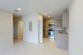 Located at 624 NE 2nd St in Dania Beach, FL, this single-story 2-bedroom, 3-bathroom residence offers a clean, modern aesthetic throughout. The open kitchen is a standout feature, equipped with stainless steel appliances including a French door refrigerator, electric range, and built-in microwave. Granite countertops, a stainless steel sink, and taupe cabinetry with sleek hardware provide both style and functionality. Light-toned large-format tile flooring runs consistently throughout the home, enhancing the bright, airy feel. The living area flows naturally from the kitchen, creating an open and cohesive layout. Both bedrooms are well-proportioned and filled with natural light through sliding glass doors dressed with vertical blinds, and each room is equipped with a ceiling fan. The primary bedroom includes access to a dedicated closet with built-in shelving. The bathrooms are finished with granite-topped vanities, neutral tile work, and soaking tub-shower combinations. Two closets provide ample storage throughout the home. Recessed lighting and a neutral color palette unify the space, making it feel open and inviting throughout.