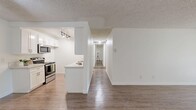 Located along Pacific Coast Highway in Torrance, California, this well-appointed 2-bedroom, 2-bathroom single-floor residence offers a practical and comfortable layout. The living room is bright and open, featuring wood-style flooring, a ceiling fan, and a large sliding glass door that invites natural light and provides views of the surrounding greenery. The semi-open kitchen is fitted with white cabinetry, light countertops, stainless steel appliances including a range and microwave, and a pass-through counter that connects seamlessly to the living area. A hallway leads to the two bedrooms, both of which are carpeted and finished with textured ceilings and clean white walls. The generously sized primary bedroom includes a mirrored sliding-door closet with built-in shelving, offering ample storage. Each bathroom is well-equipped; one features a wide vanity with light countertops, wood-style flooring, and a large mirror, while the other includes a tub-shower combination with glass sliding doors and built-in shelving. Throughout the residence, a consistent neutral color palette and clean finishes create a bright, cohesive aesthetic suited for everyday living.