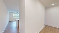 Located at 2219 Jack Ln in Bel Air, Maryland, this well-appointed 2-bedroom, 2-bathroom residence offers a clean, modern aesthetic across a single thoughtfully designed floor. The open-concept kitchen and living area serves as the heart of the home, showcasing a large center island with white quartz countertops, white shaker cabinetry, a classic subway tile backsplash, and a full suite of stainless steel appliances. Pendant lighting above the island adds a warm, contemporary touch, while light wood-tone flooring flows throughout the main living spaces. The spacious primary bedroom features plush carpeting, a ceiling fan, and ample natural light, complemented by generous closet space — the home includes an impressive seven closets in total. The second bedroom also offers carpeted flooring, a ceiling fan, and bright windows with outdoor views. Each bathroom is finished with marble-style tile flooring; the primary bath includes a glass-enclosed walk-in shower, while the second bath features a tiled tub-shower combination, both with white vanities and brushed nickel hardware. Two hallways connect the rooms efficiently, and large windows throughout the home invite abundant natural light, creating a bright and airy atmosphere. This residence combines functional design with modern finishes for comfortable everyday living.
