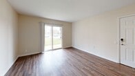Located at 5401 Lowerfield Dr in Louisville, KY, this one-bedroom, one-bathroom unit offers a well-organized single-floor layout designed for comfortable everyday living. The living room serves as the heart of the space, featuring warm wood-style flooring, neutral beige walls, and a ceiling fan. A sliding glass door floods the room with natural light and opens to an outdoor view, creating a bright and inviting atmosphere. The living area connects seamlessly to the kitchen, which is outfitted with warm honey-toned cabinetry, light granite-style countertops, a double basin sink, and stainless steel appliances including an electric range and over-the-range microwave. The bedroom is a generously sized retreat with plush neutral carpet, two closets with classic panel doors, and ample wall space. An additional carpeted room provides flexible space that could serve as a secondary living or study area. The bathroom features wood-style flooring consistent with the main living areas, a wood-toned vanity with under-sink storage, and a well-lit mirror above. Clean white trim and neutral tones throughout the unit create a cohesive, move-in-ready aesthetic that is both functional and easy to personalize.