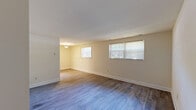 Located at 1114 Tace Dr in Essex, Maryland, this one-bedroom, one-bathroom unit offers a well-organized single-floor layout designed for efficient, comfortable living. Hardwood-style flooring runs throughout much of the unit, providing a cohesive and clean aesthetic from room to room.

The living room serves as the welcoming entry point of the unit, featuring a front door with natural light filtering in through a window with blinds, and access to additional rooms via an open corridor. The galley-style kitchen is thoughtfully designed with light wood cabinetry lining both walls, white countertops, and a full suite of white appliances including a gas range, refrigerator, and microwave. A stainless steel sink adds a modern touch, while durable light-toned flooring completes the practical workspace.

The bedroom is notably generous in size, offering ample room for furnishings and featuring two side-by-side sliding door closets, providing substantial built-in storage. The room also includes a window allowing natural light to brighten the space.

The bathroom is clean and functional, appointed with a wood-toned vanity with white countertop, a full tub-shower combination with white tile surround, and neutral tile flooring. The overall design throughout the unit is simple, neutral, and move-in ready.