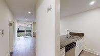 Located at 510 S Normandie Ave in the heart of Los Angeles, this single-floor unit offers a clean, modern layout designed for comfortable city living. The open-concept living area is finished with light wood-style flooring and recessed lighting throughout, creating a bright and airy atmosphere. A wall-mounted heater and a dedicated wall AC unit provide year-round climate control. Sliding glass doors lead directly to a private balcony, allowing natural light to fill the living space and offering views of the surrounding neighborhood.

The kitchen is thoughtfully appointed with rich granite countertops, white cabinetry, and a suite of stainless steel appliances including a gas range, refrigerator, and dishwasher. A double-basin sink with a peninsula counter adds both functionality and a natural divider between the kitchen and living area.

The bathroom features a bold dark marble vanity countertop paired with a large mirror and a separate shower and toilet area, lending an elevated, polished feel. An additional vanity area with granite countertops and built-in storage drawers provides a dedicated grooming space. Tile flooring in the bathroom and hallway areas complements the overall design aesthetic, making this unit a well-rounded and practical space in a prime Los Angeles location.