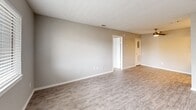Located at 1610 E McKinney St in Denton, TX, this single-floor 2-bedroom, 2-bathroom unit offers a practical and comfortable layout designed for everyday living. The living room welcomes you with durable wood-look luxury vinyl plank flooring, neutral gray walls, a textured ceiling, and a front-facing window that brings in natural light. The open feel of the space is enhanced by clean white trim and easy access to adjoining rooms. Both bedrooms feature soft wall-to-wall carpeting and neutral tones, creating a calm and restful atmosphere. The primary bedroom offers a generous footprint with its own dedicated closet, while the second bedroom also includes a window for natural light and a closet for storage. Each of the two bathrooms is equipped with a full tub-and-shower combination, finished with stylish gray subway tile surrounds and wood-look flooring, giving a clean and modern appearance. A dedicated laundry area with shelving above accommodates a full-size washer and dryer. Throughout the unit, consistent neutral color palettes, textured ceilings, and practical finishes provide a cohesive and move-in-ready environment suited for a range of occupants.
