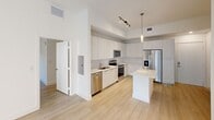 This contemporary apartment in Bogota offers 990 square feet of well-designed living space. The single-story layout includes three bedrooms, with the primary bedroom boasting a generous 170 square feet. The open-concept design creates a seamless flow between living areas, enhancing the sense of space.

The kitchen is a highlight, featuring crisp white cabinetry, stainless steel appliances, and a practical island. Light wood-look flooring runs throughout, complementing the bright, neutral walls. Two modern bathrooms showcase large-format tile and glass shower enclosures, providing a spa-like atmosphere.

Large windows in the bedrooms allow for ample natural light, while horizontal blinds offer privacy control. The apartment includes three closets for storage. Recessed lighting and track fixtures provide layered illumination options.

The clean lines, neutral color palette, and minimalist design create a fresh, modern ambiance throughout the space. This efficient floor plan maximizes the use of every square foot, making it an ideal urban dwelling in the heart of Bogota.
